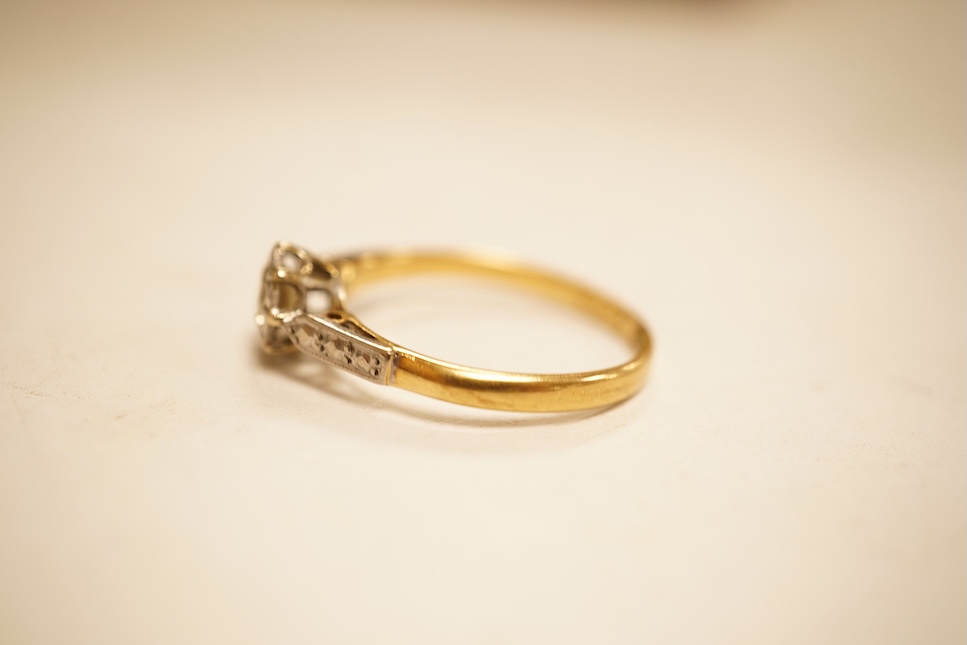 A modern yellow metal and single stone diamond set ring, with baguette and round cut diamond cluster set shoulders, total diamond weight approx. 0.50ct, size J/K (sizing spheres), gross weight 4.6 grams.